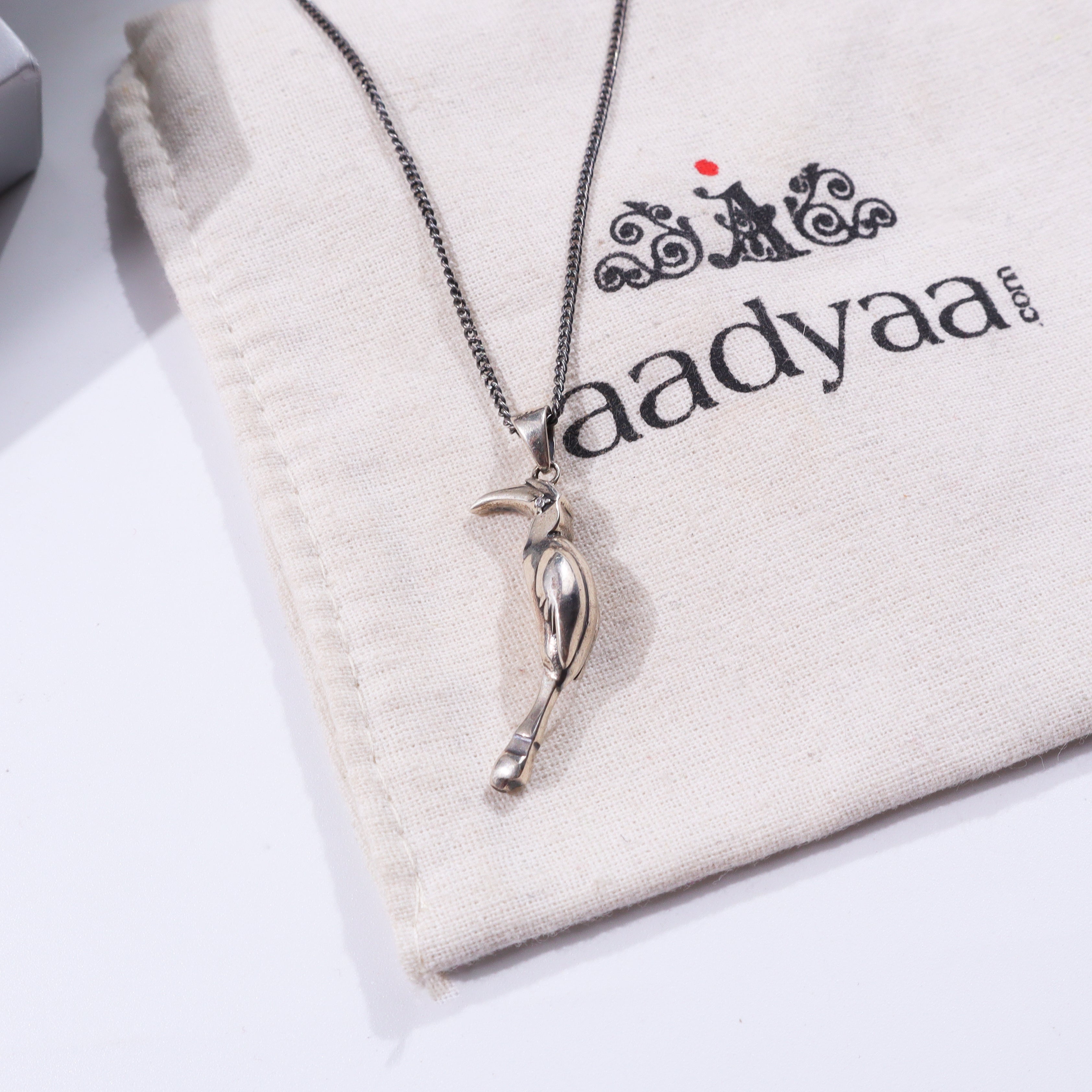 Silver Hornbill pendant on fabric