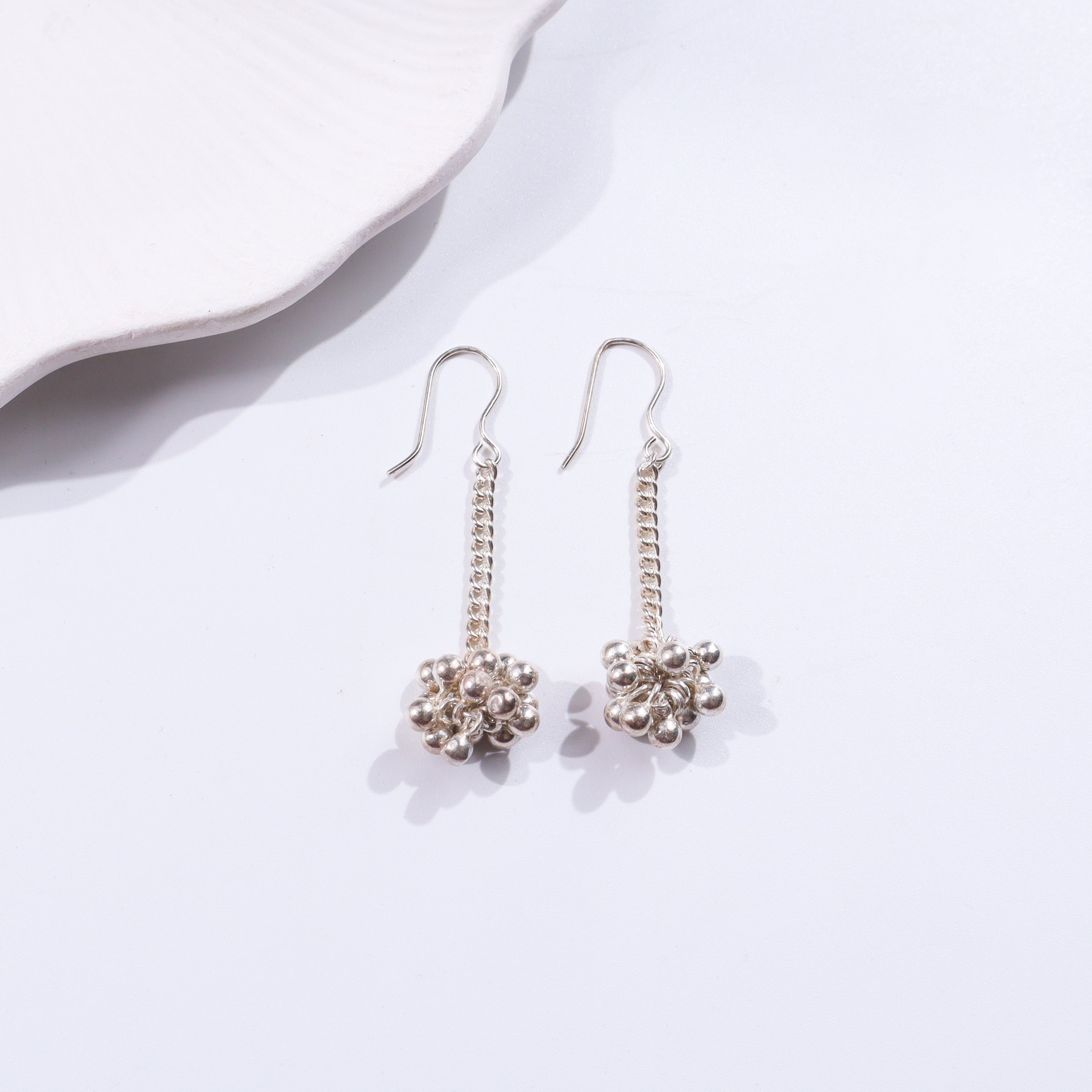 Silver earrings with chain and bead design