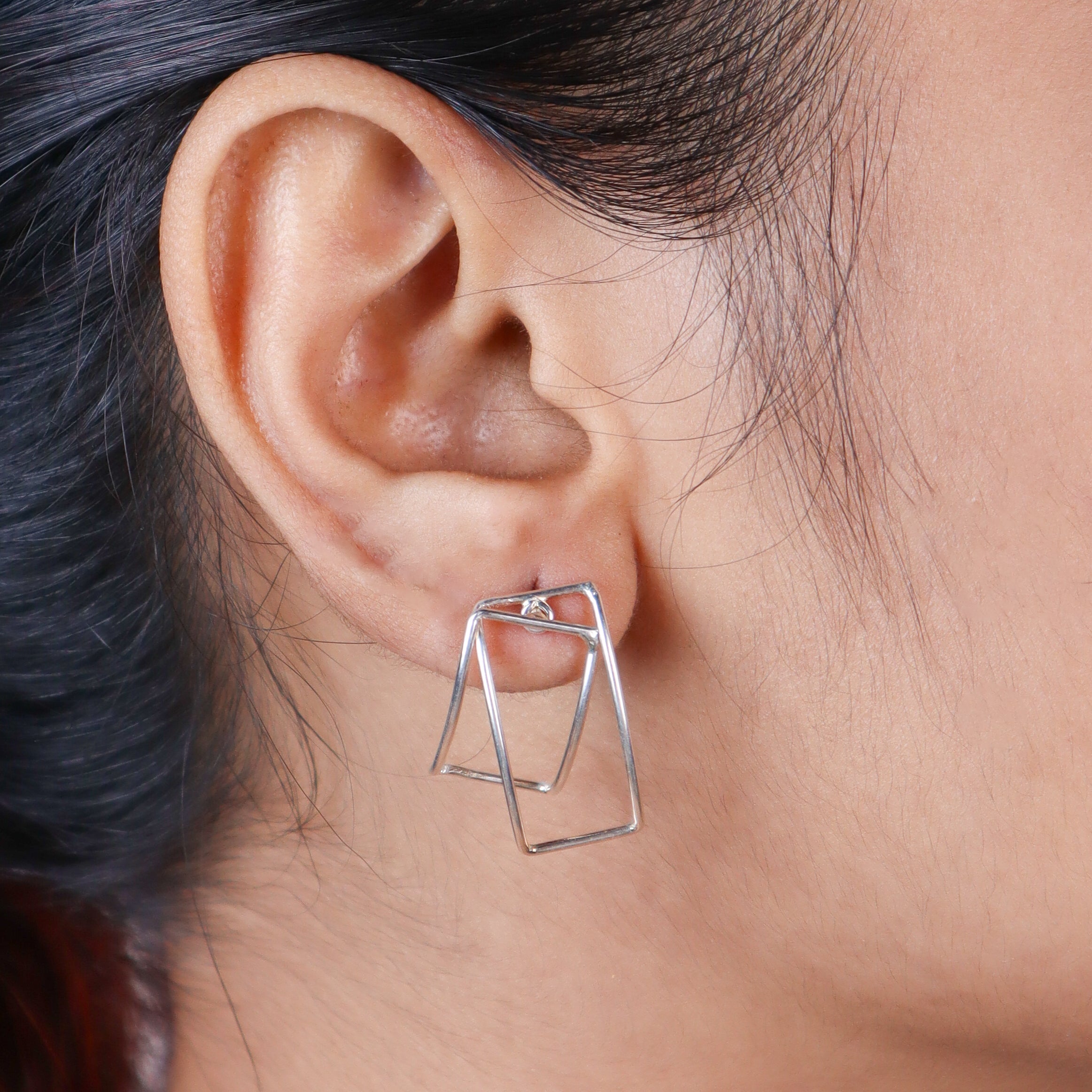 arc frame detailing on silver hoop earrings