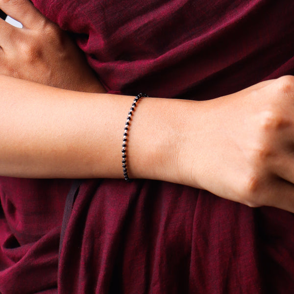 Black beaded bracelet on wrist