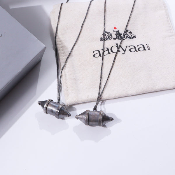Silver oxidized Kashmiri Dejhoor earrings on white fabric