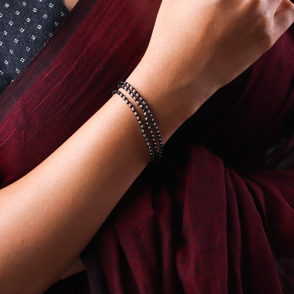 Black beaded layered bracelet on wrist