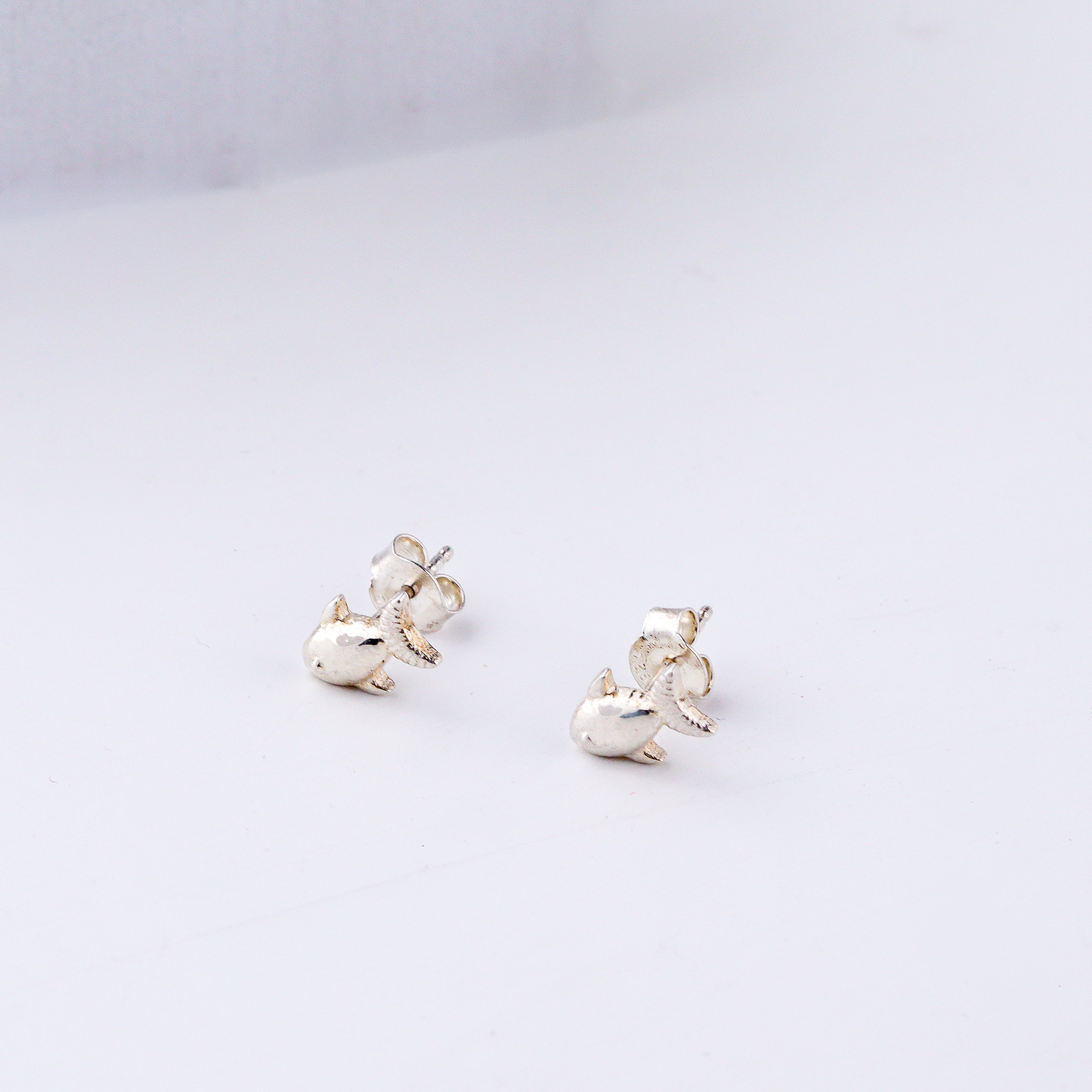 Minimal silver fish motif studs polished finish
