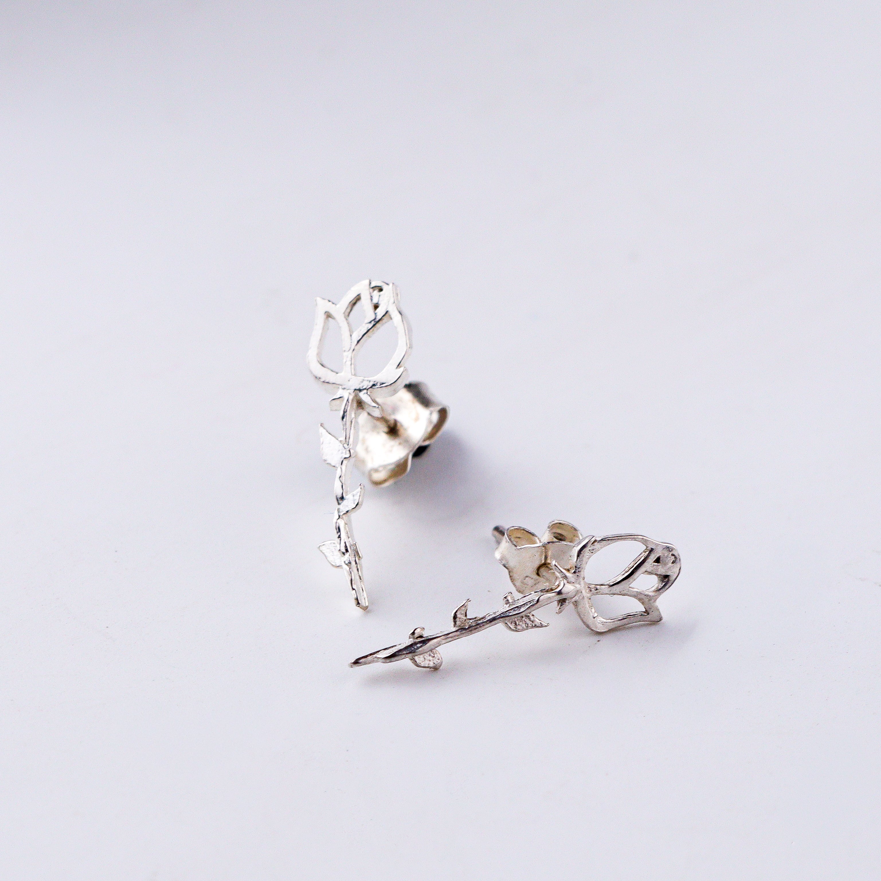 Silver rose flower earrings close-up handcrafted detailing