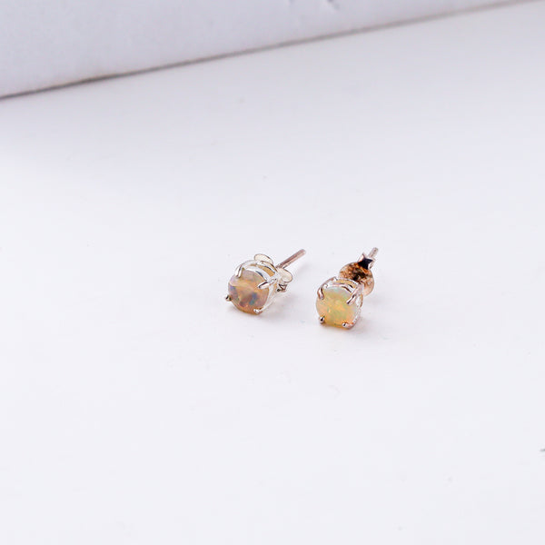 Silver opal earrings on white background
