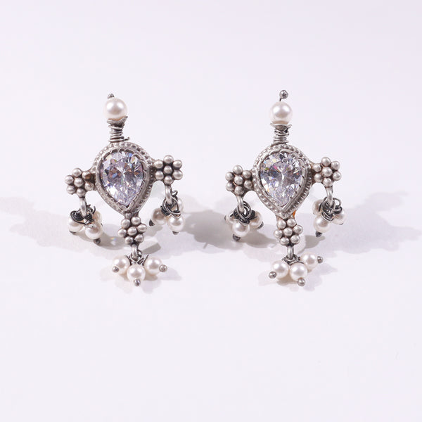 Silver earrings with pearl accents and crystal center