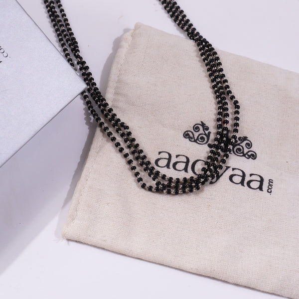 Black beaded silver mangalsutra on beige fabric pouch