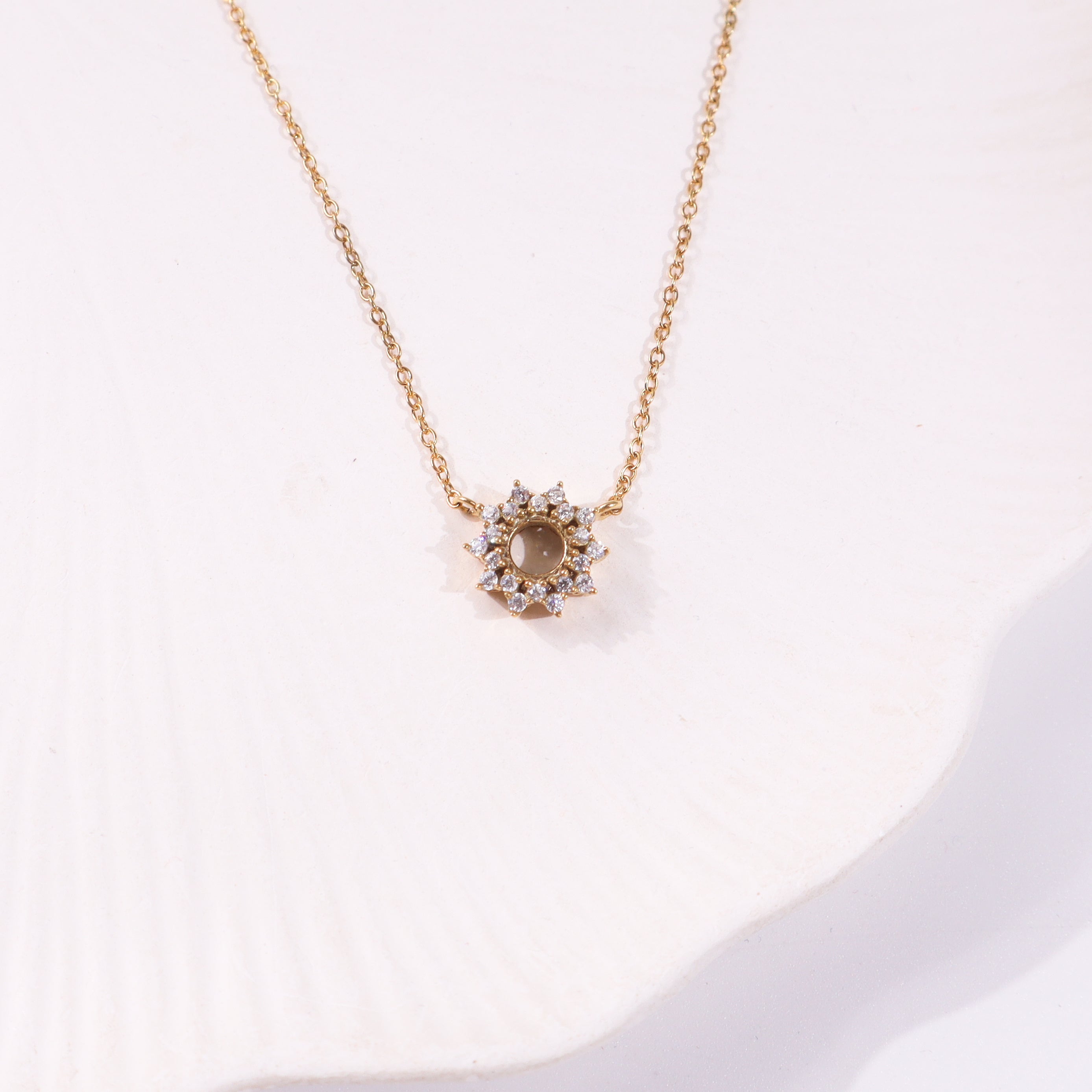 Gold chain necklace with star-shaped pendant and sparkling stones