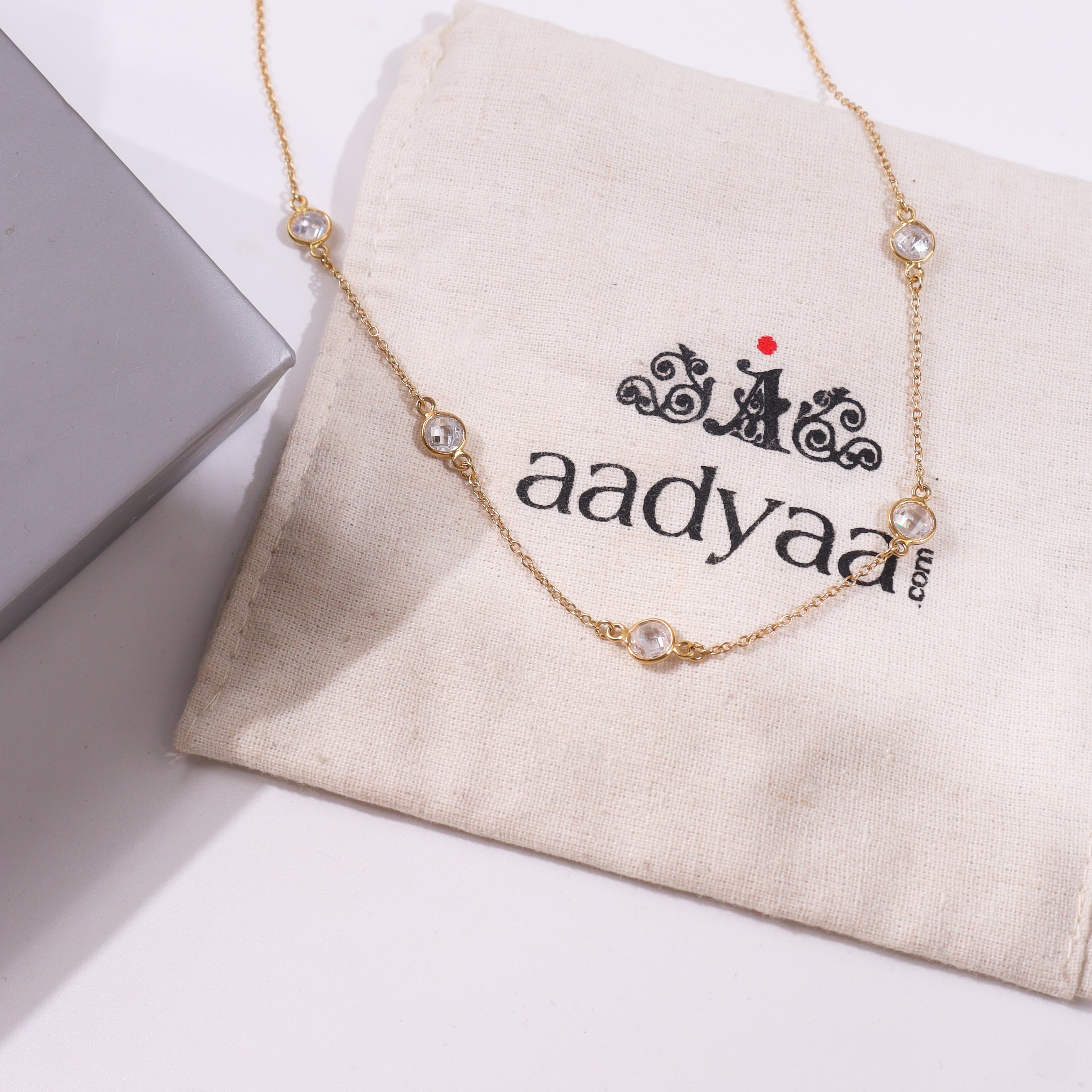 Gold chain necklace with clear gemstone accents