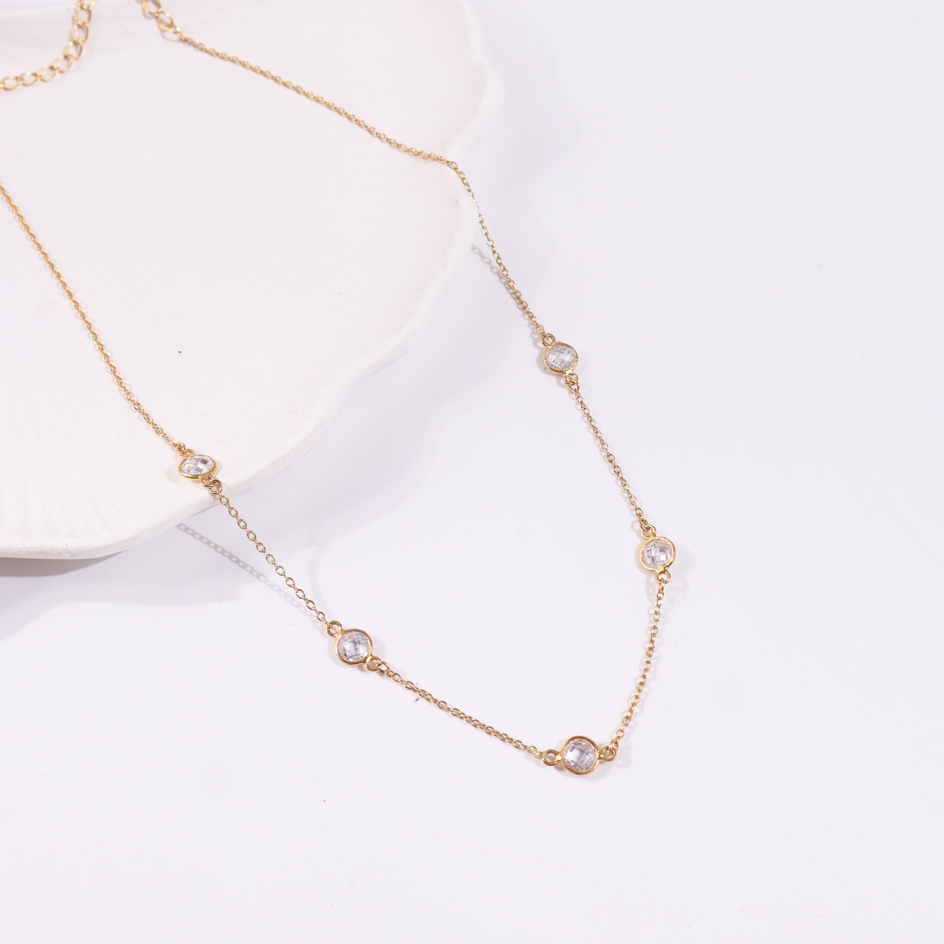 Gold chain necklace with clear gemstone accents