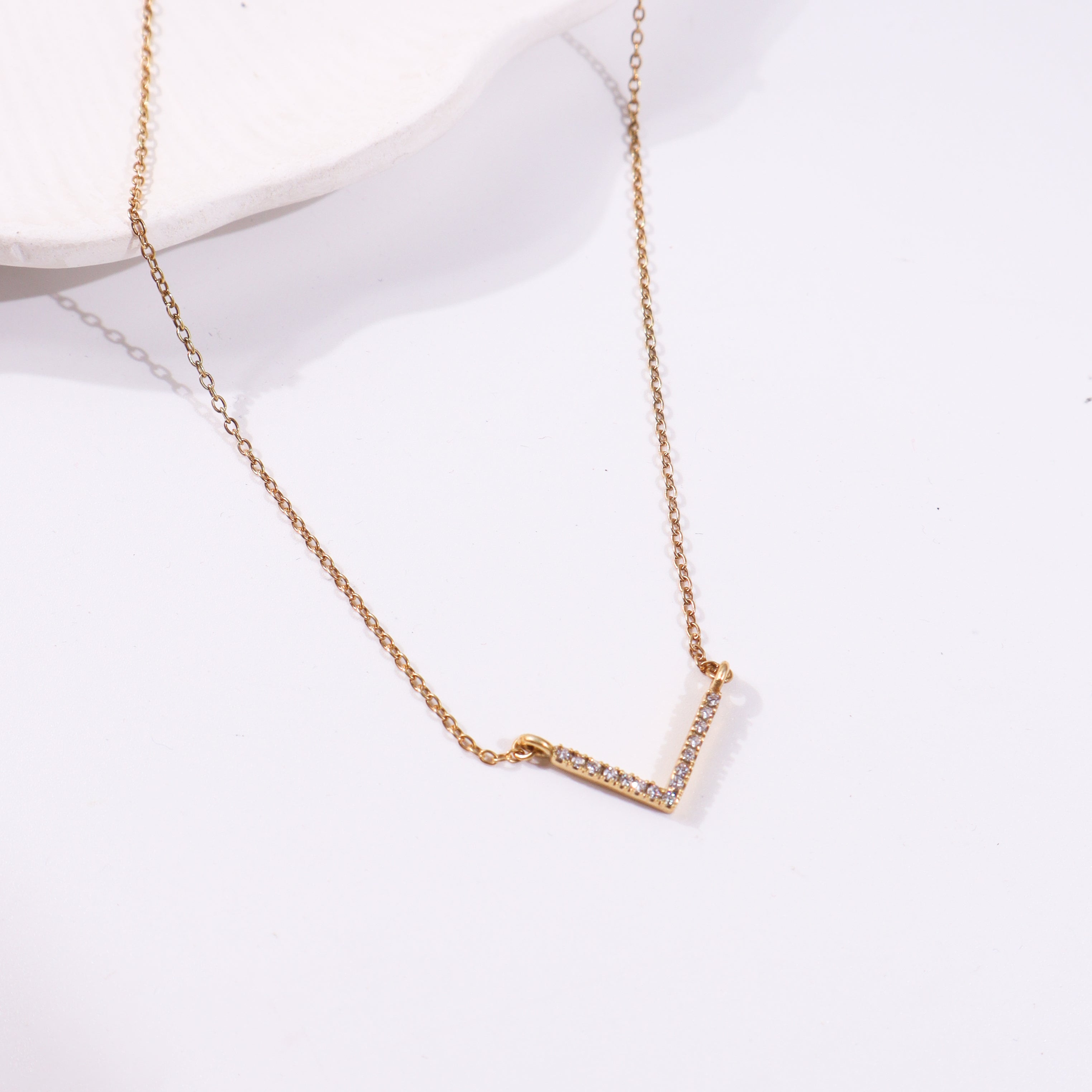 Gold chain with diamond-studded V-shaped pendant