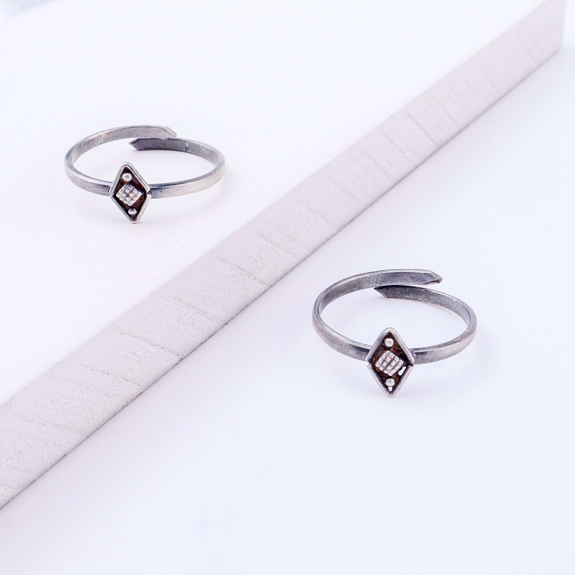 Angled view of tiny silver textured diamond adjustable toe ring