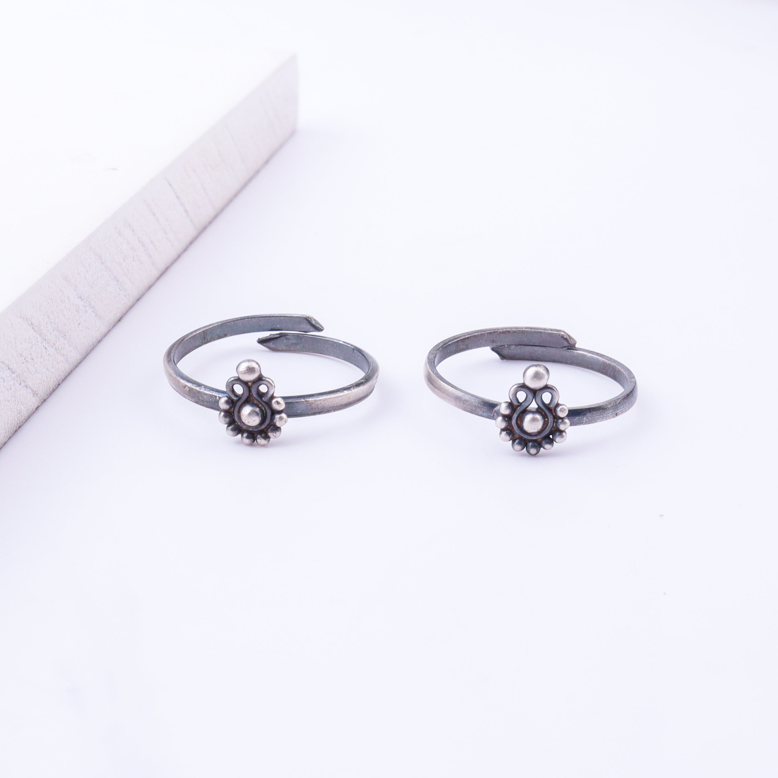 Model wearing tiny silver adjustable Gopadma toe ring