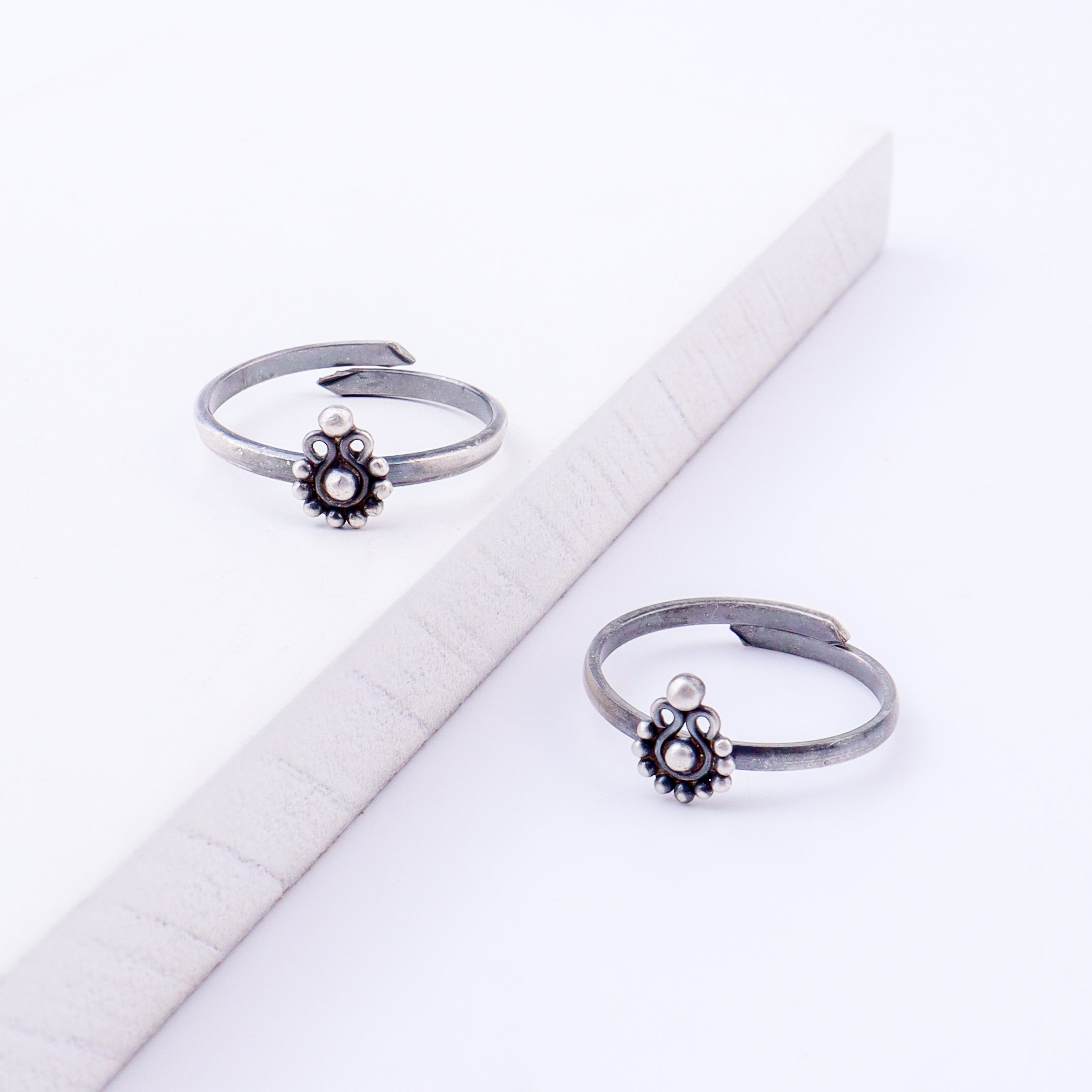 Angled view of tiny silver Gopadma adjustable toe ring