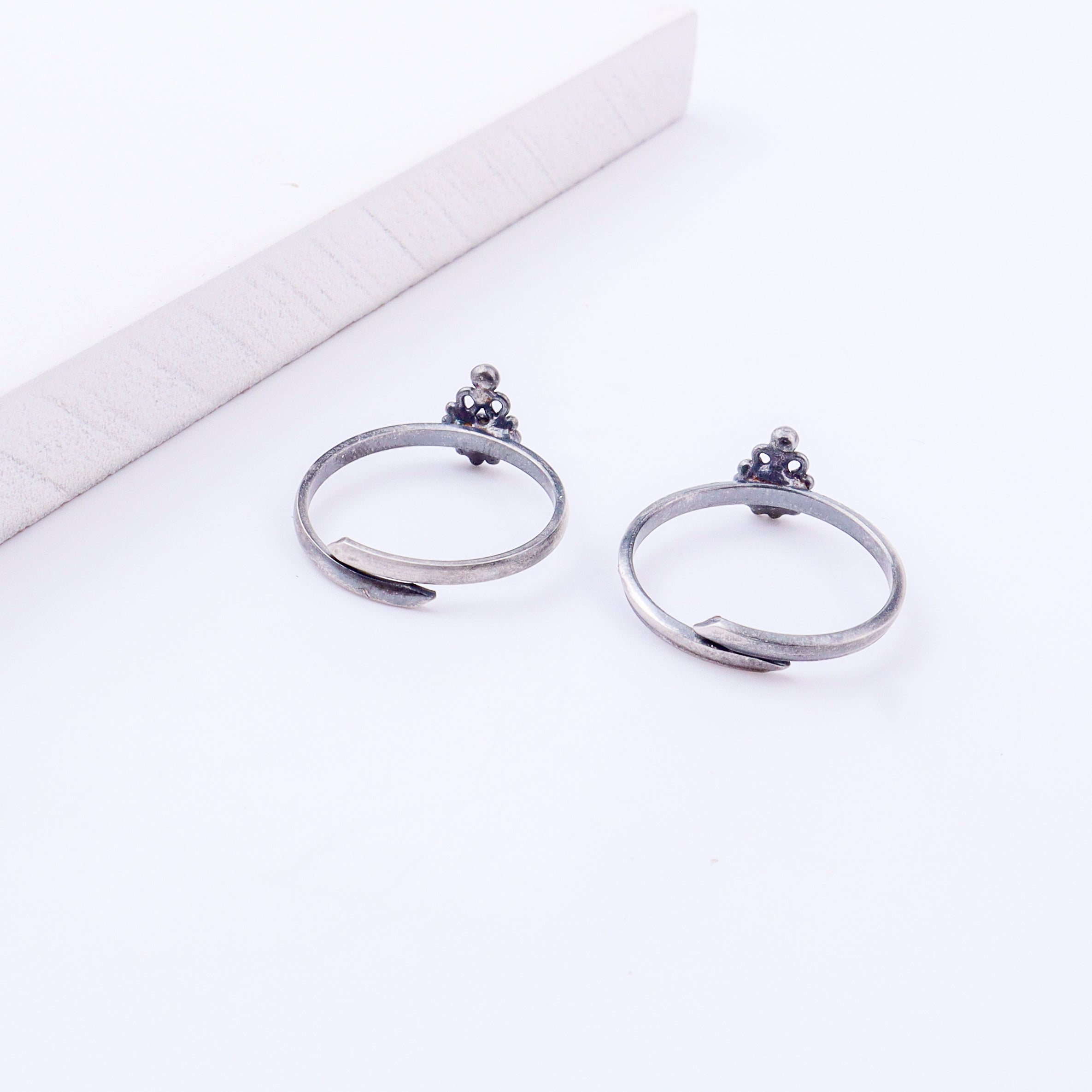 Detail shot highlighting polished silver finish and open band