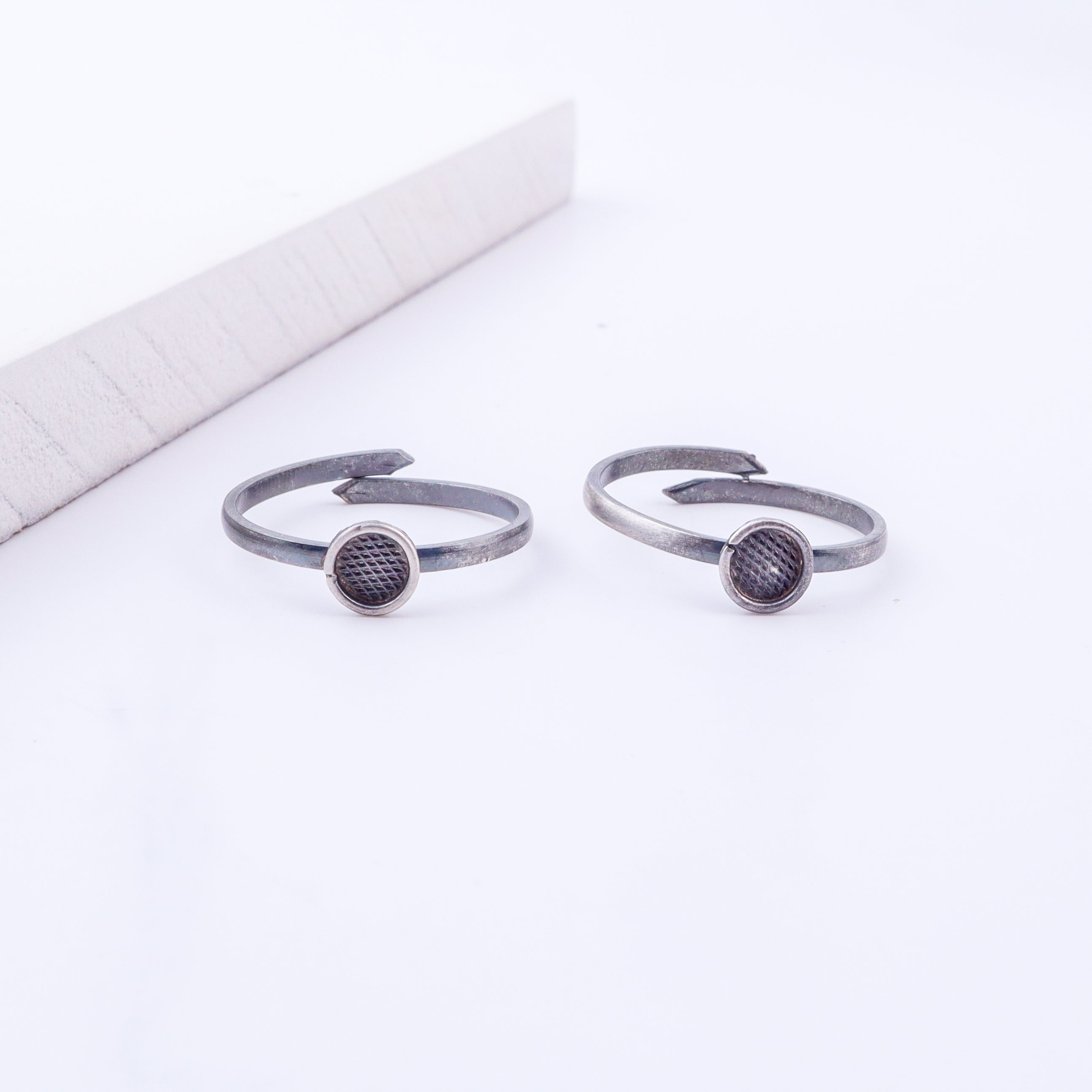 Model wearing tiny silver adjustable textured circle toe ring