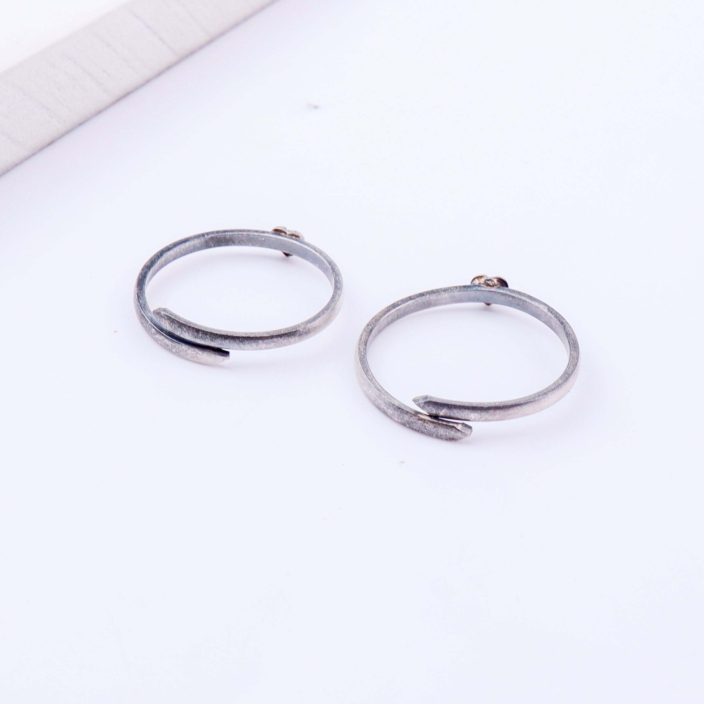 Detail shot highlighting polished silver heart and open band