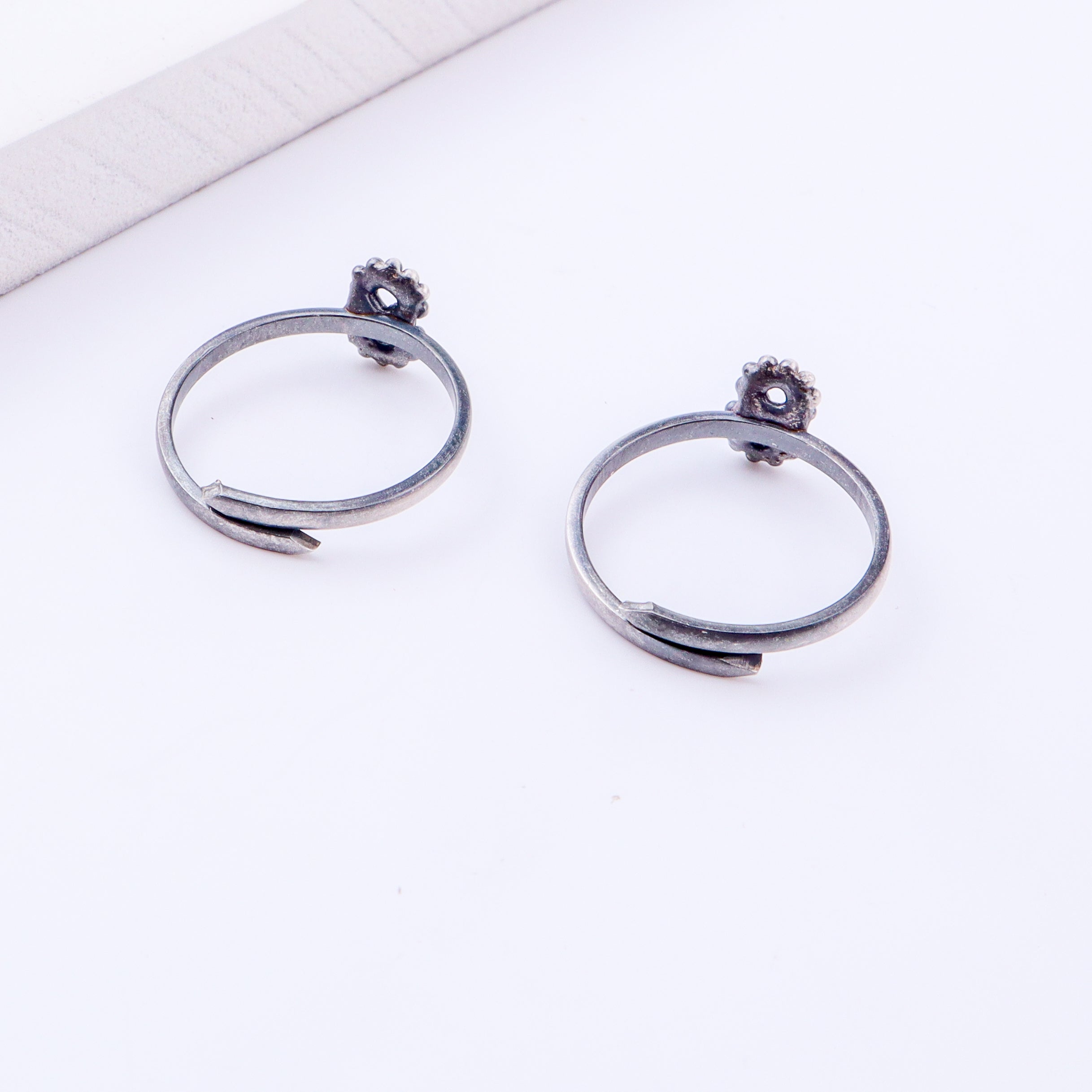 Detail shot highlighting polished silver finish and open band