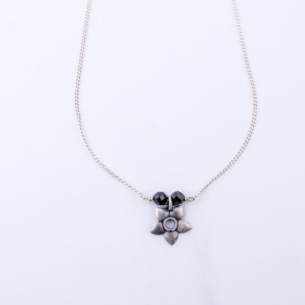 Silver floral pendant necklace with black beads