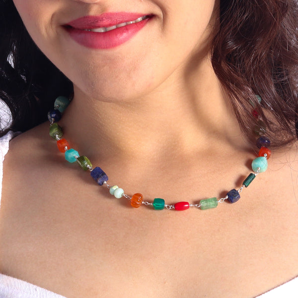 Woman wearing multicolor gemstone necklace