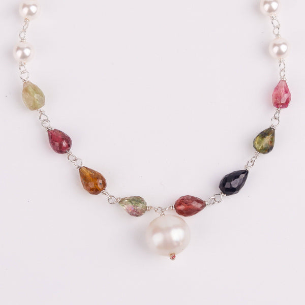 Macro detail of lustrous pearls and semiprecious stones with polished 92.5 sterling silver finish