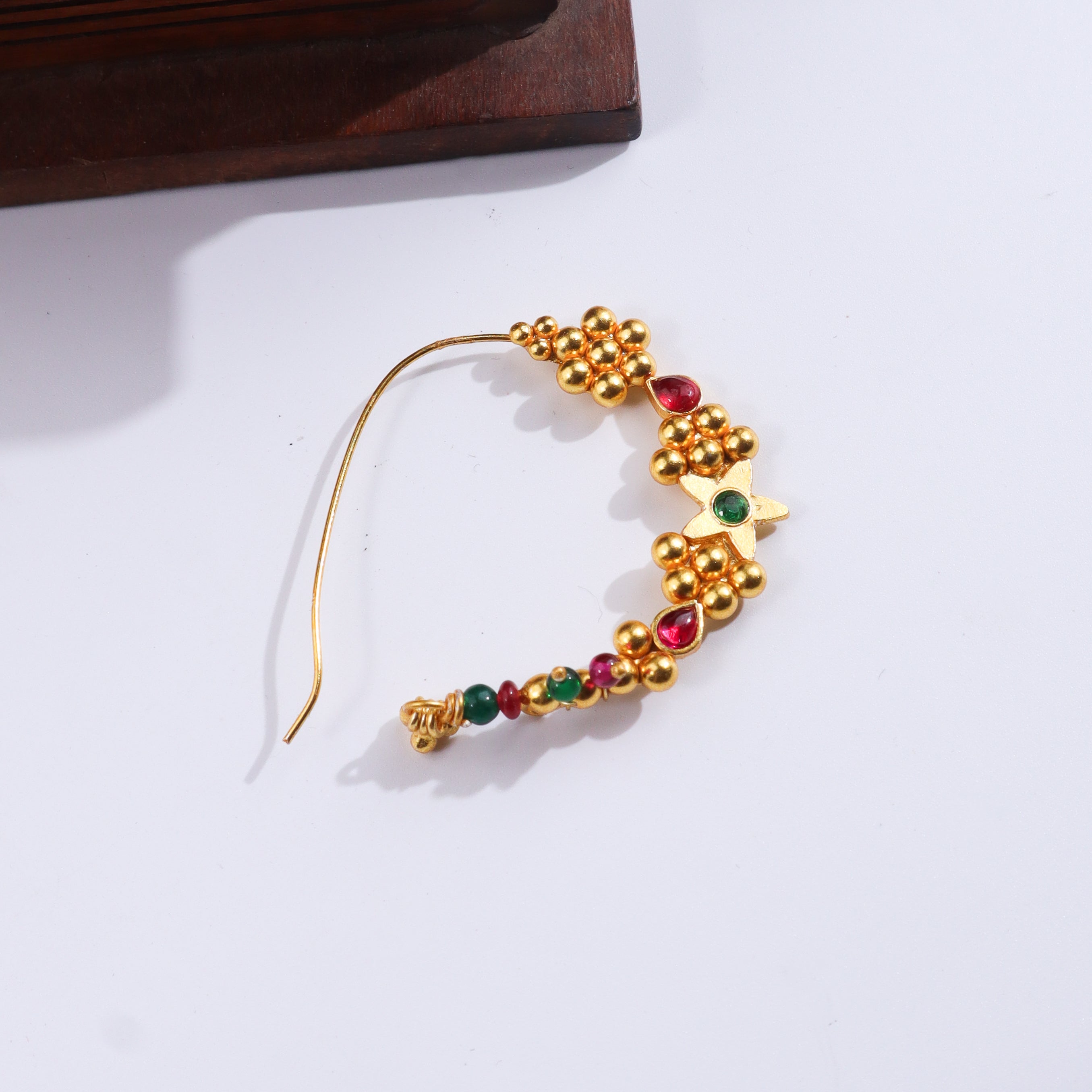 Gold and colored bead earrings with floral design on white background