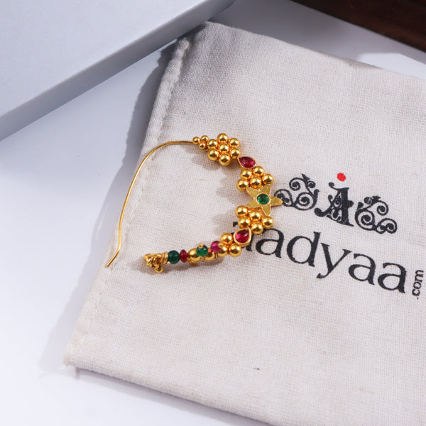 Gold and red gemstone Nath on white fabric