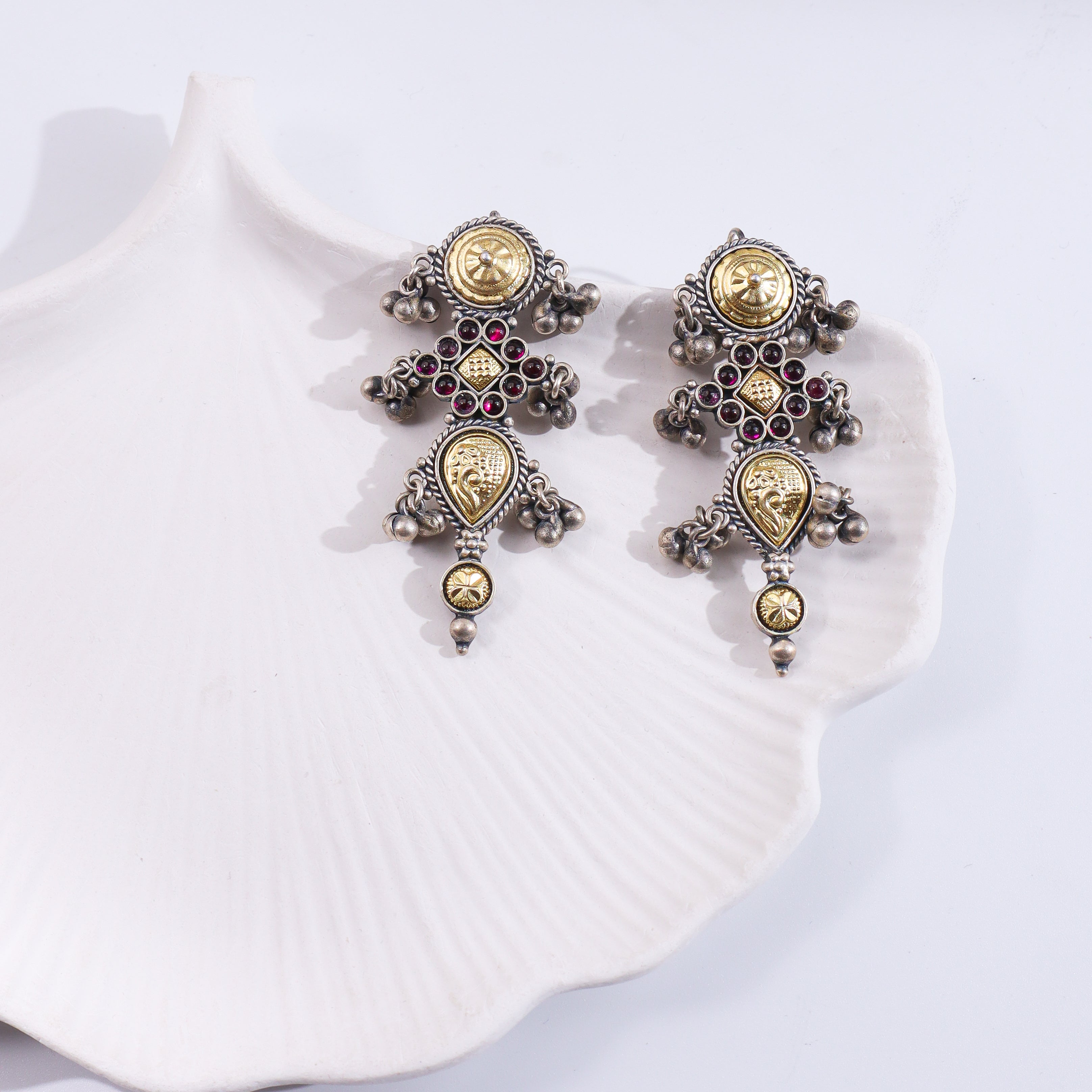 Silver Rajasthani earrings with intricate design and dangling elements