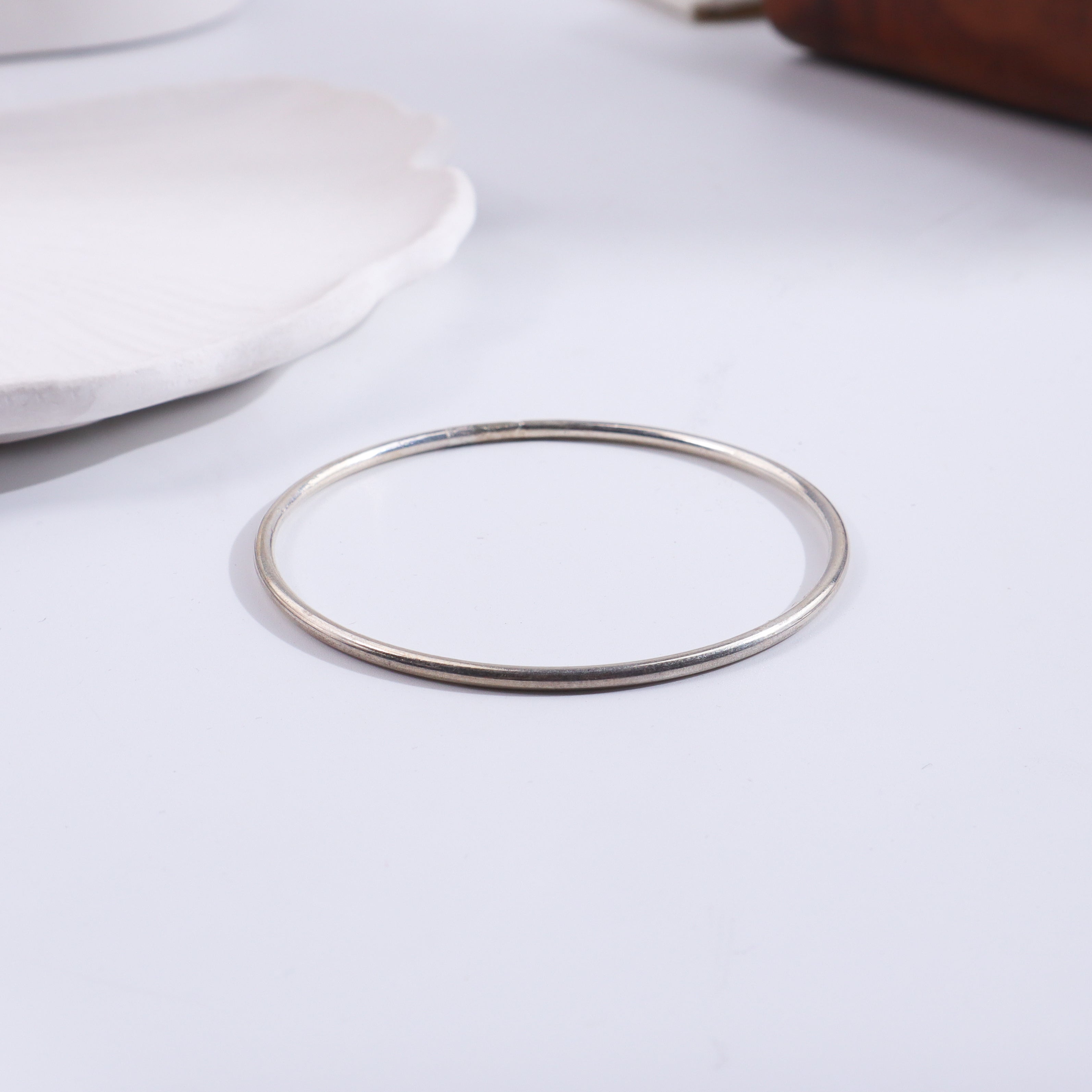 Silver flat bangle on white background