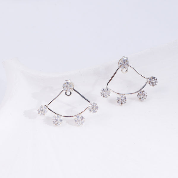 Silver flower CZ earrings on white background, side view
