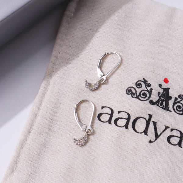 Silver CZ Moon Earring on beige fabric
