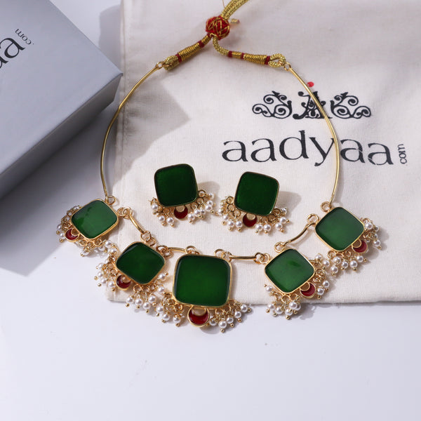Green and red meenakari jewelry set with pearls and gold accents