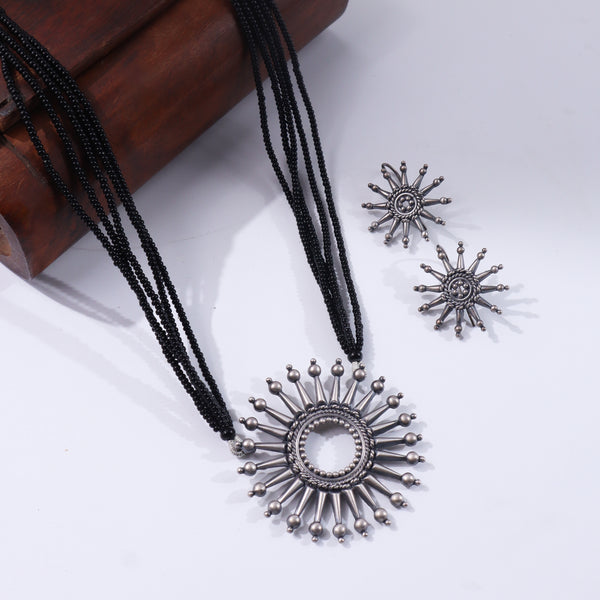 Black beaded silver necklace with sun-shaped pendant