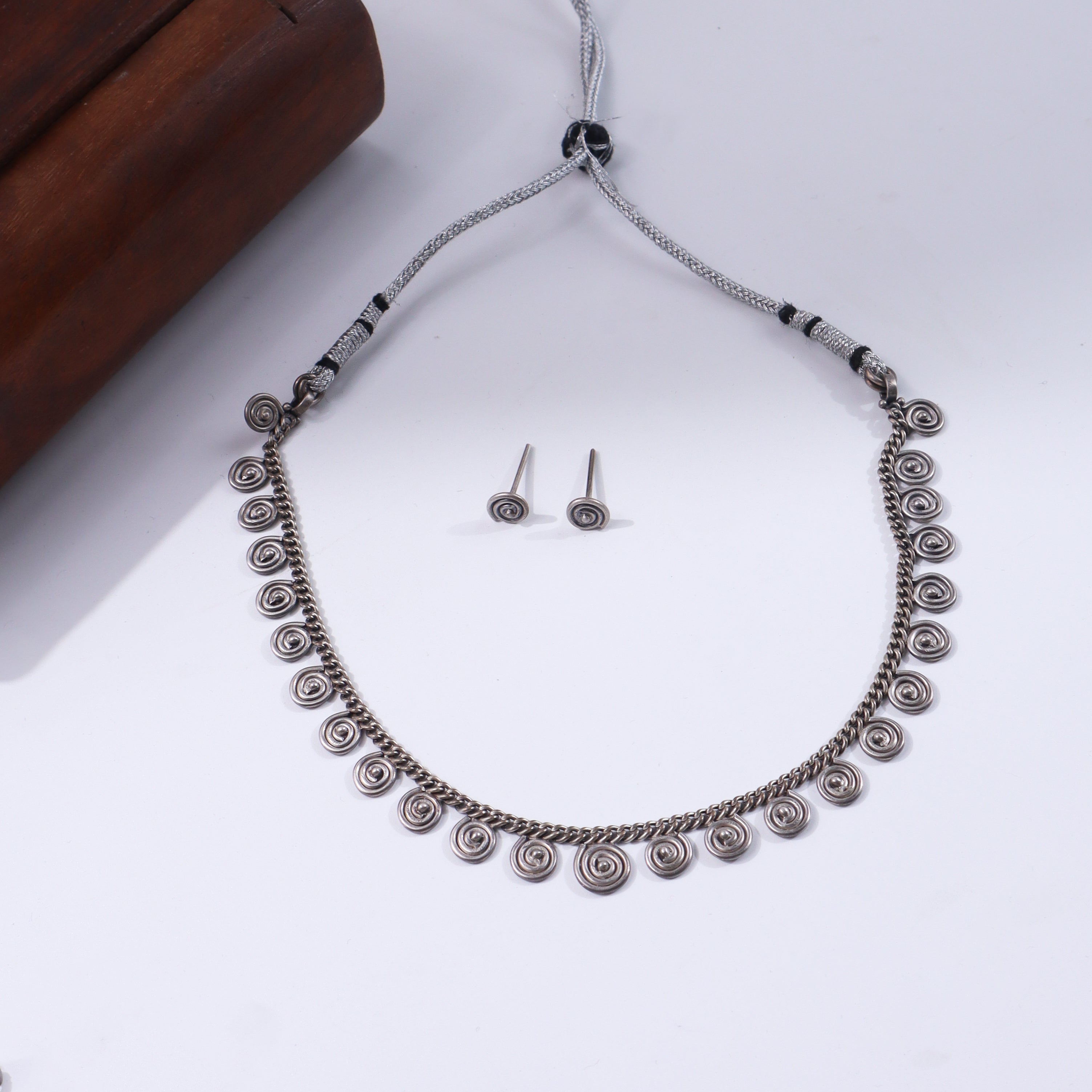 Silver jewelry set with spiral motifs and oxidized finish