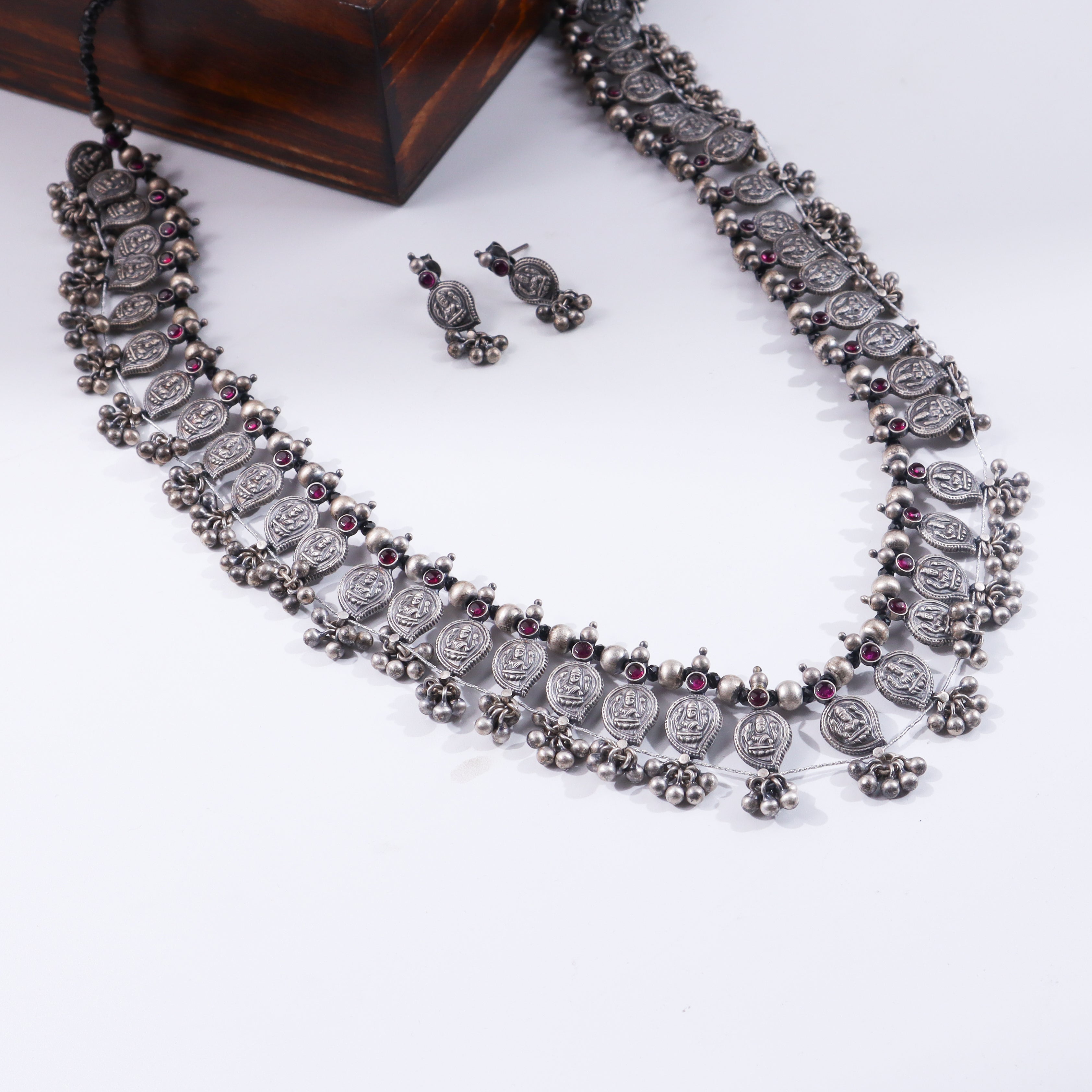Silver oxidized necklace with red gemstones and traditional coin motifs