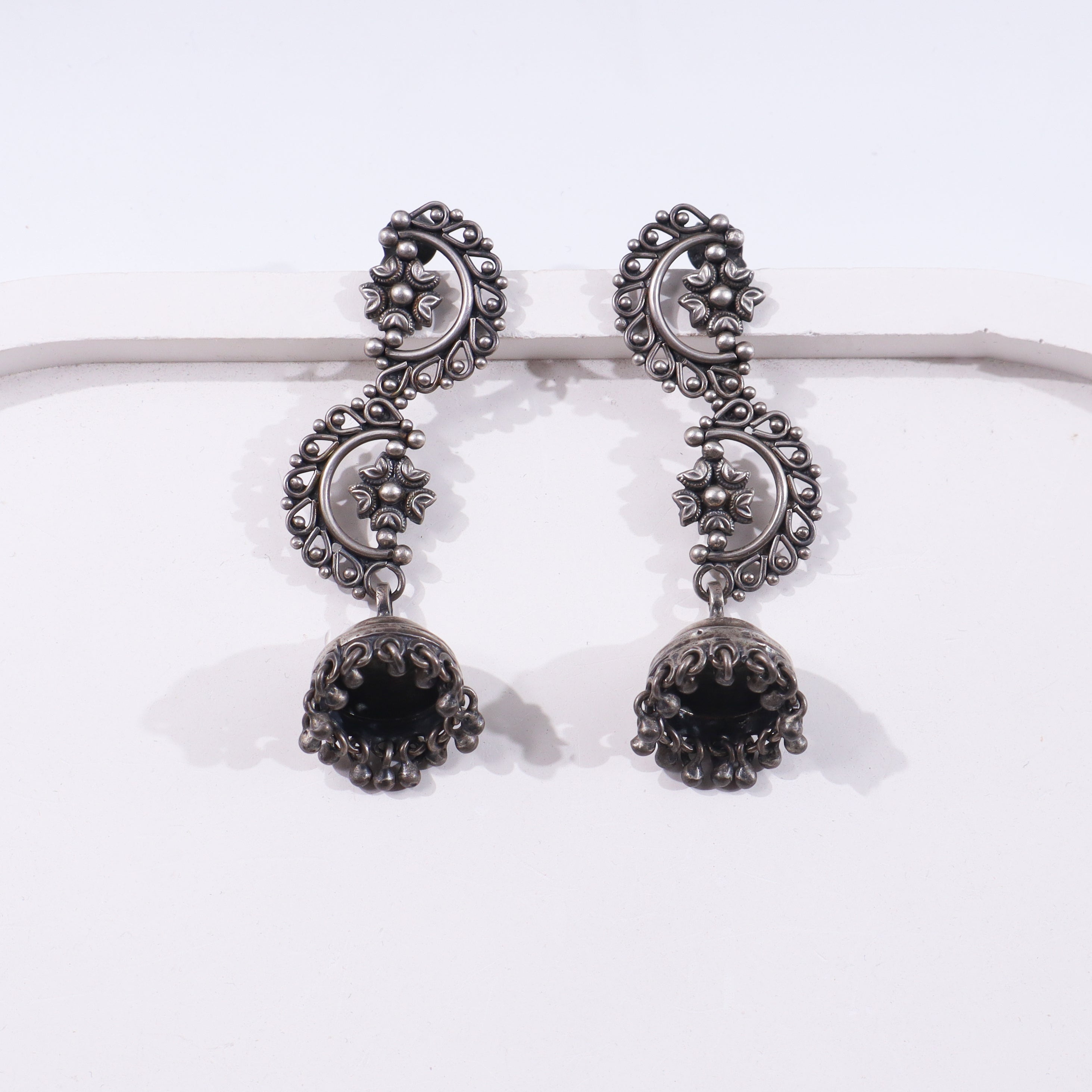 Sterling silver earrings with intricate filigree design and dangling black beads