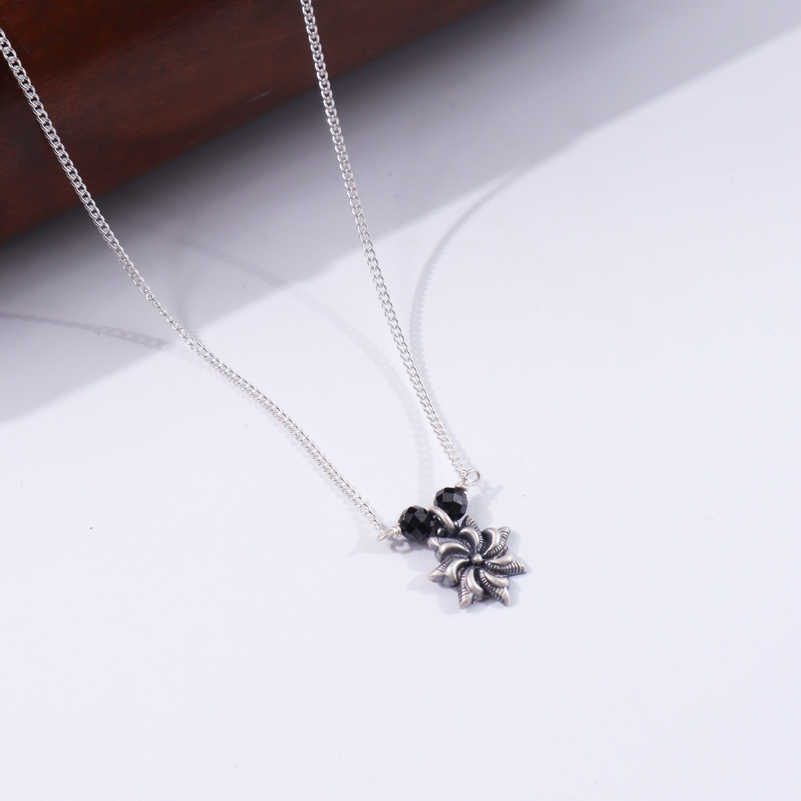 Silver chain with black bead pendant