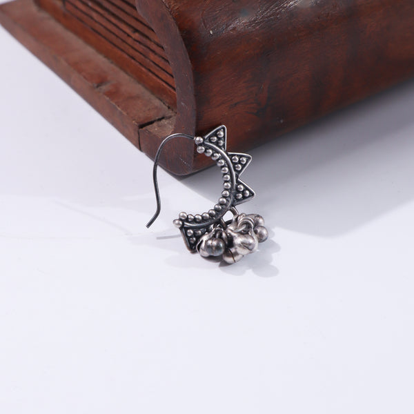 Silver butterfly earring on wooden box