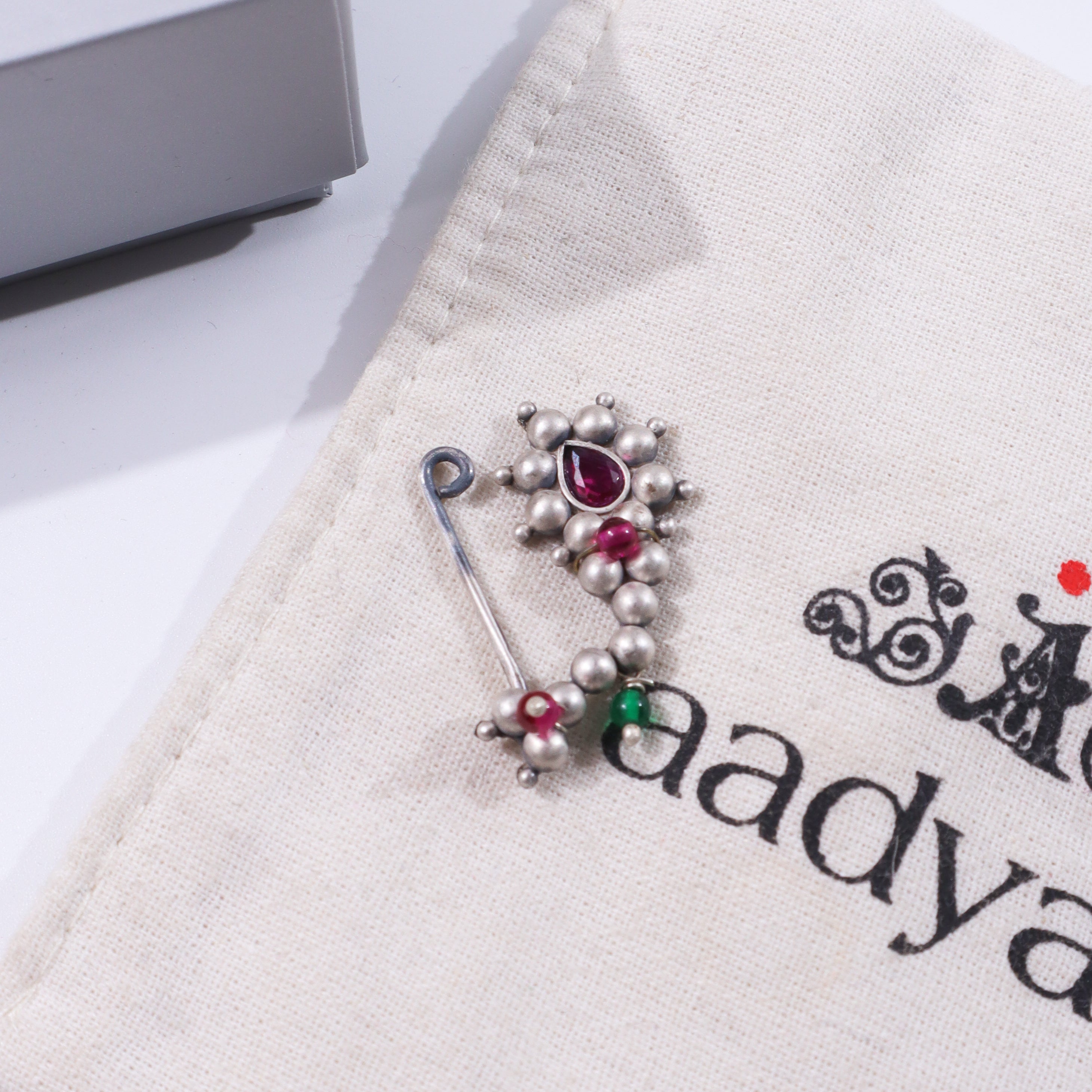 Sterling silver Maharashtrian Nath clip-on jewelry with red gemstone detail