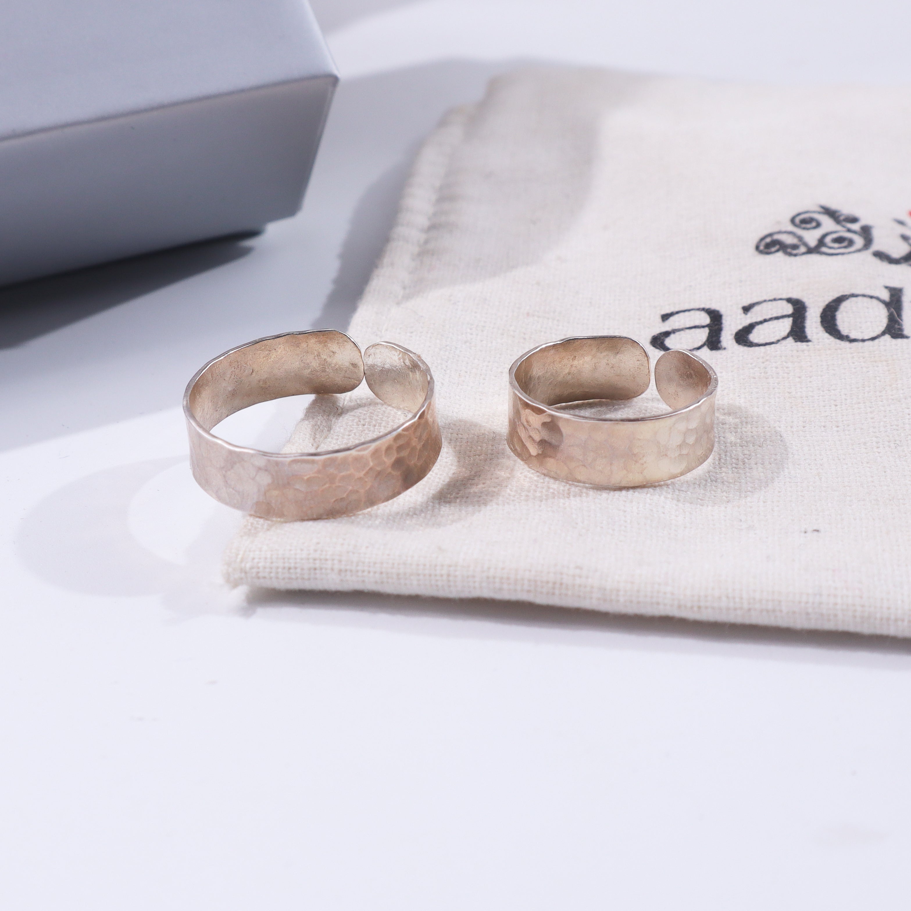 Hammered couple rings in 92.5% silver on white fabric