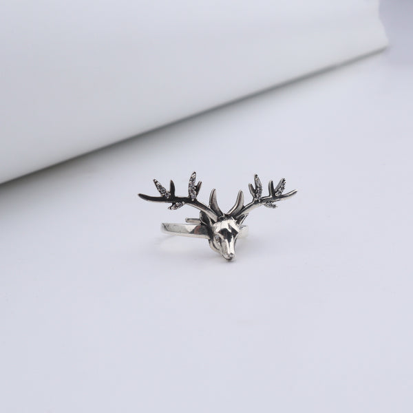 Silver deer ring with detailed antlers and gemstone accents