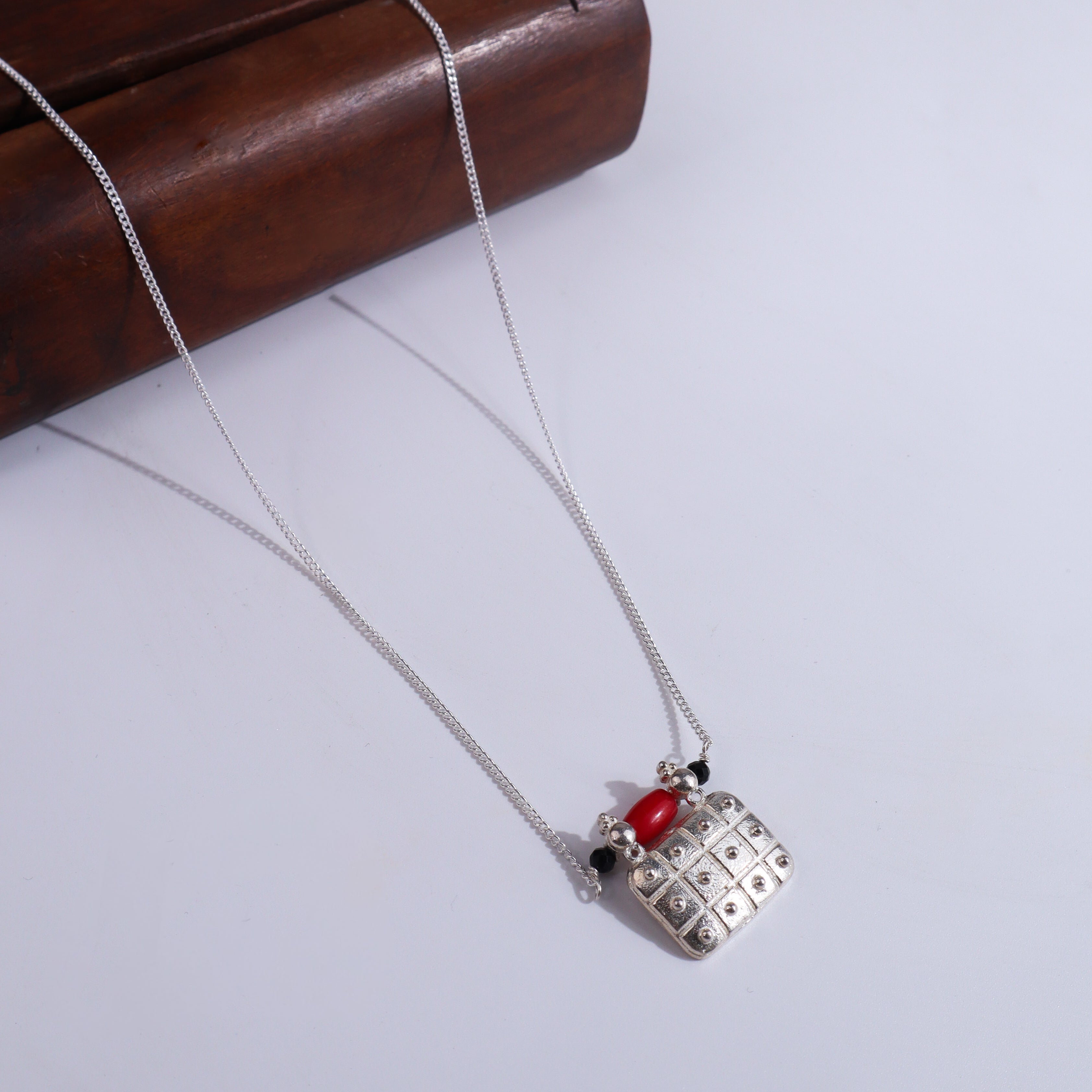 Silver pendant necklace with red and black beads
