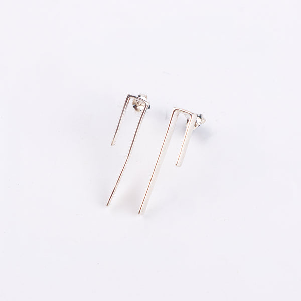Silver minimalist earrings on white background