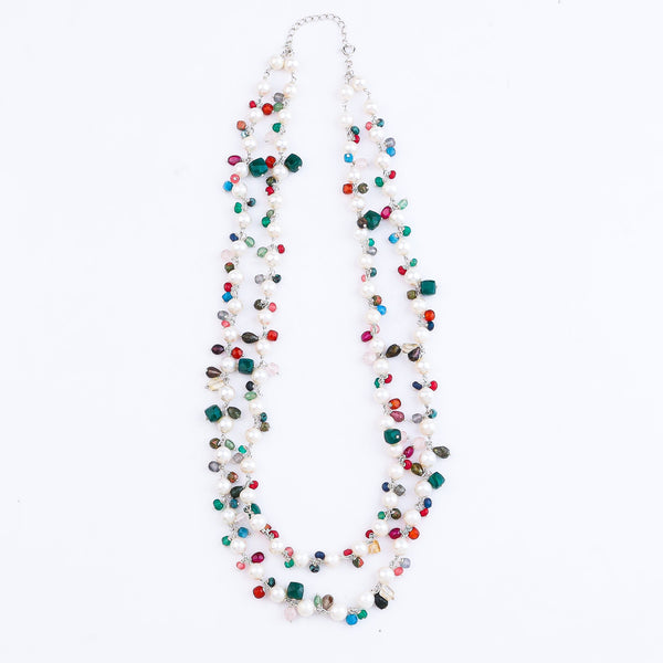 Layered multicolored pearl necklace on model's neck