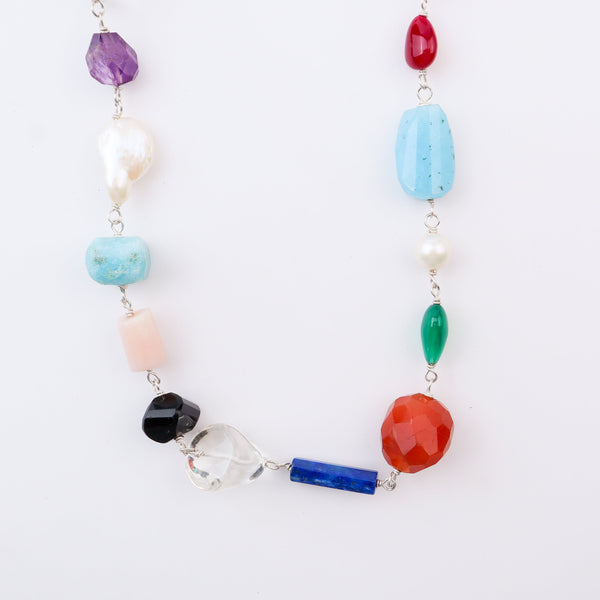 Close-up of multicolour stone necklace on white background