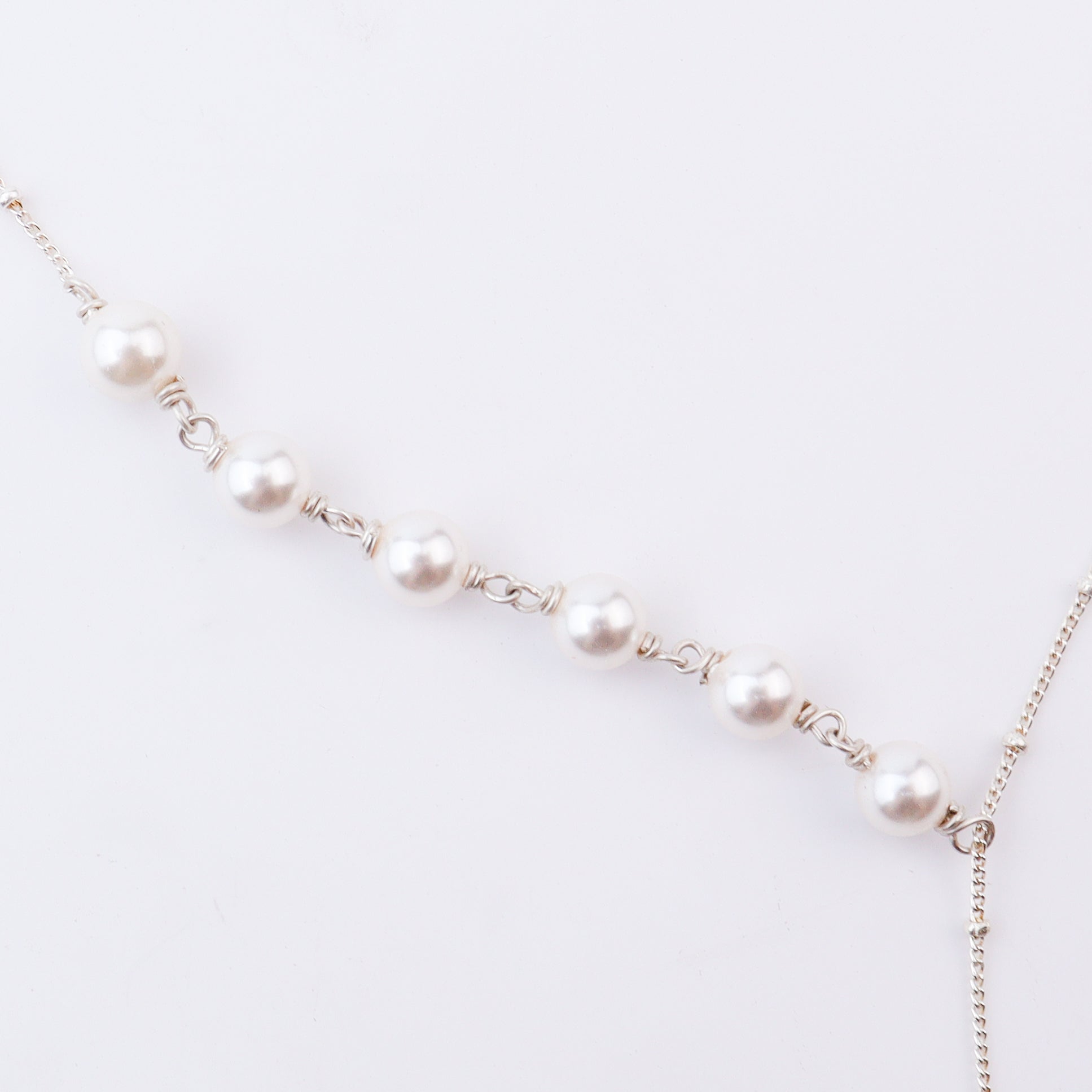 Close-up of silver pearl necklace chain