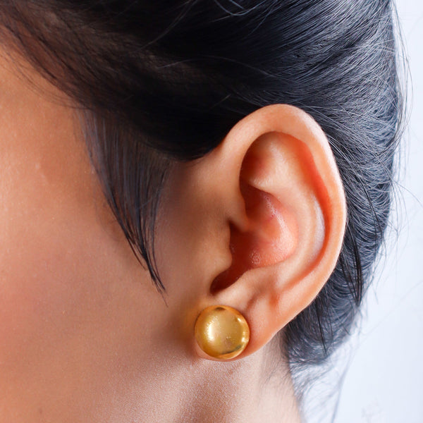 Close-up of gold earrings on white background