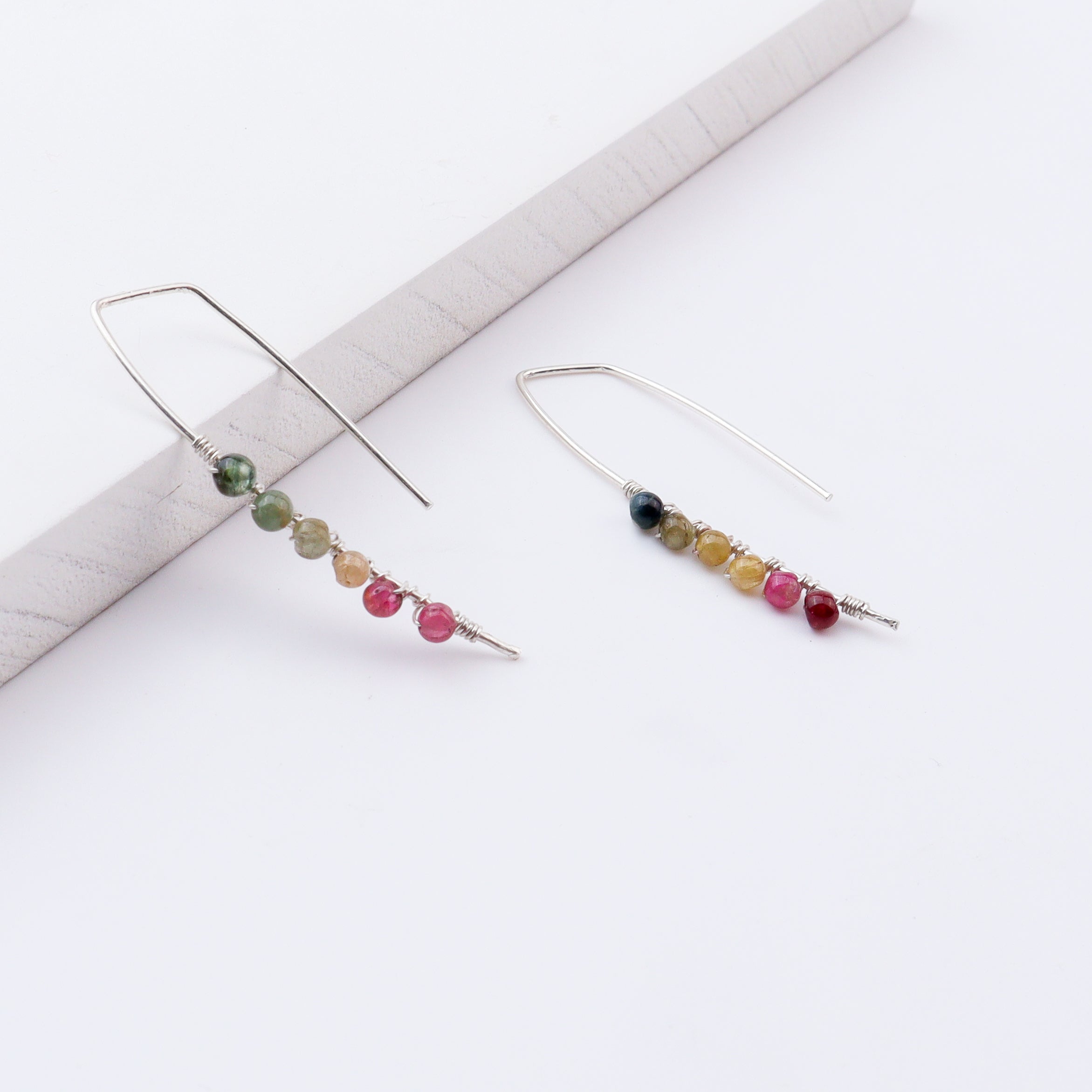 Close-up of silver multicolour stone earrings