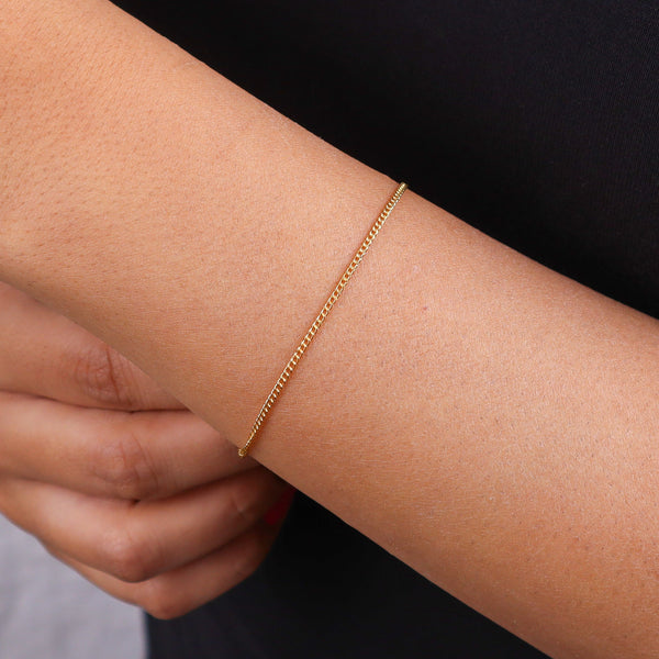 Close-up of gold chain bracelet on wrist