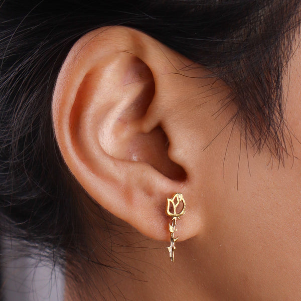 Close-up of gold floral stud earrings